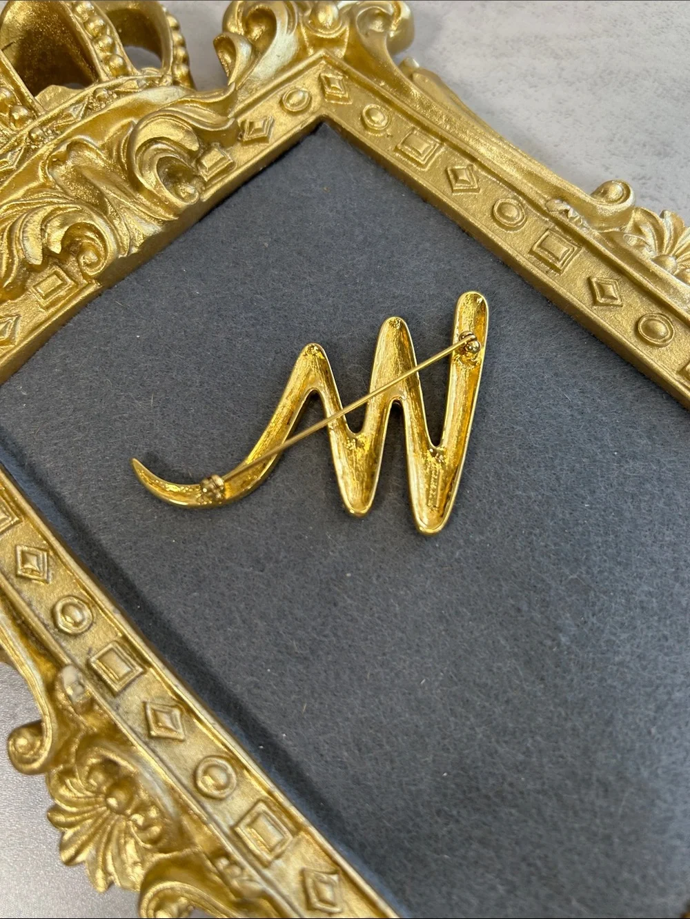 Vintage Trifari Black Enamel and Gold Crescent Brooch with Crystal Accent